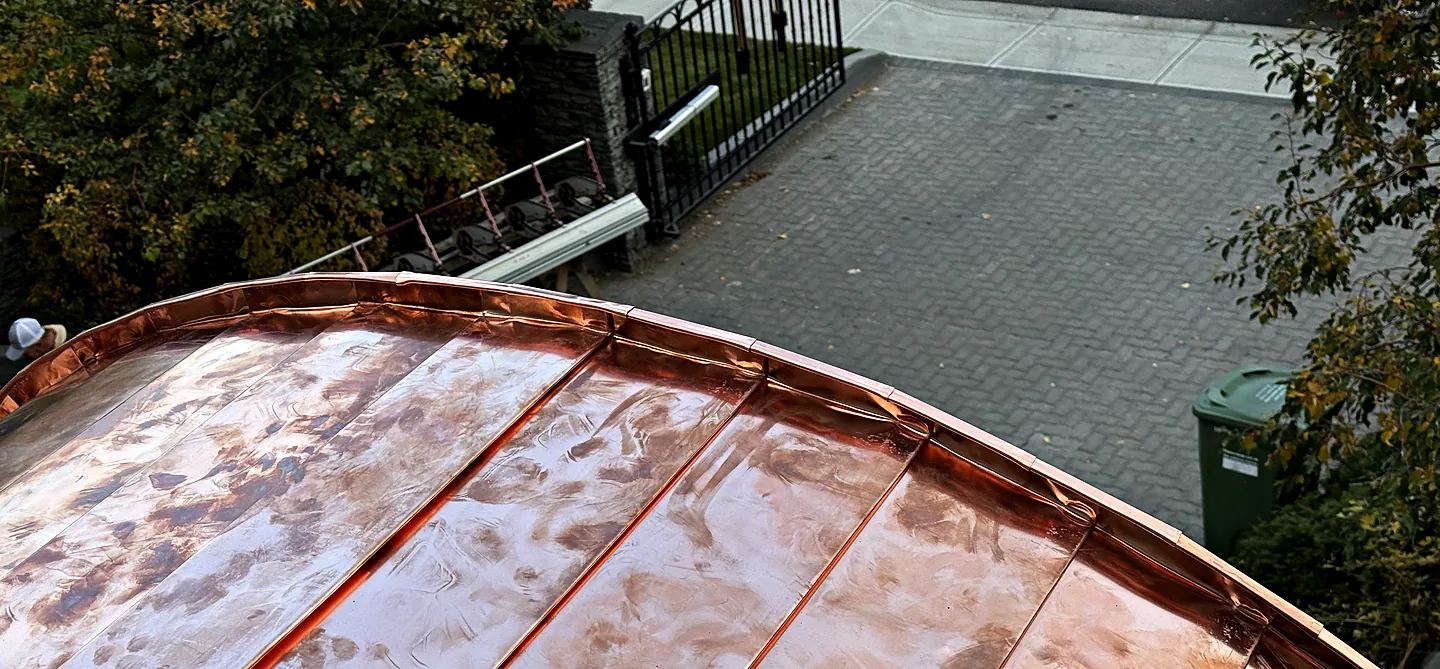Curved copper roof with fresh standing seams