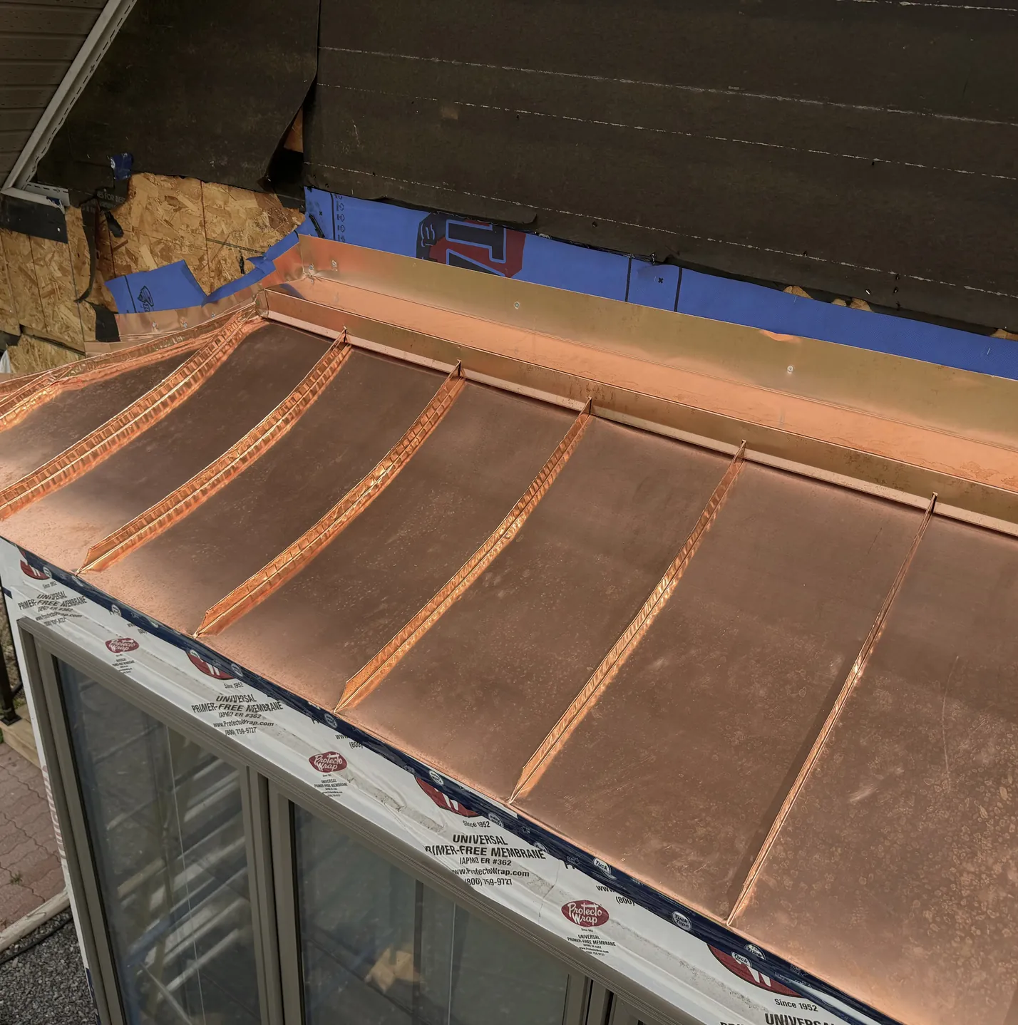 Copper canopy being seamed