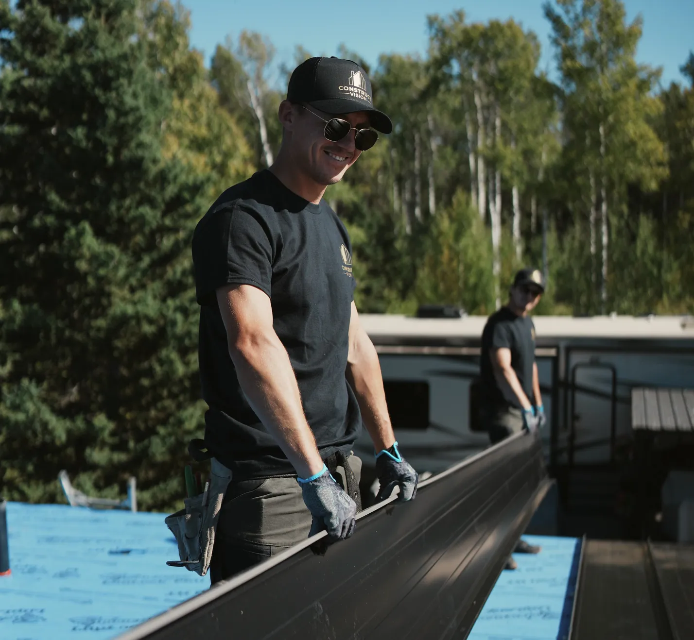 Crew carrying a long standing seam panel on site