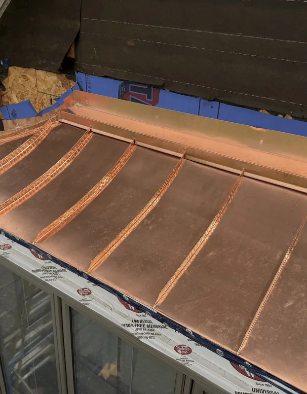 Copper canopy being seamed