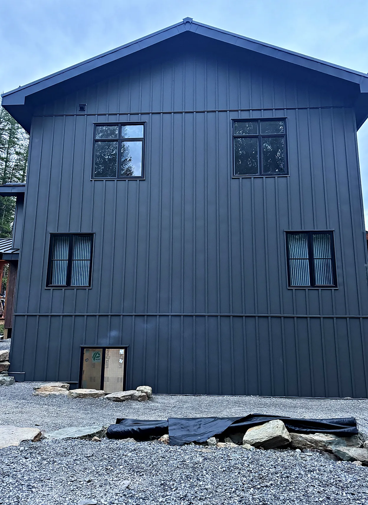 House clad in dark vertical metal siding