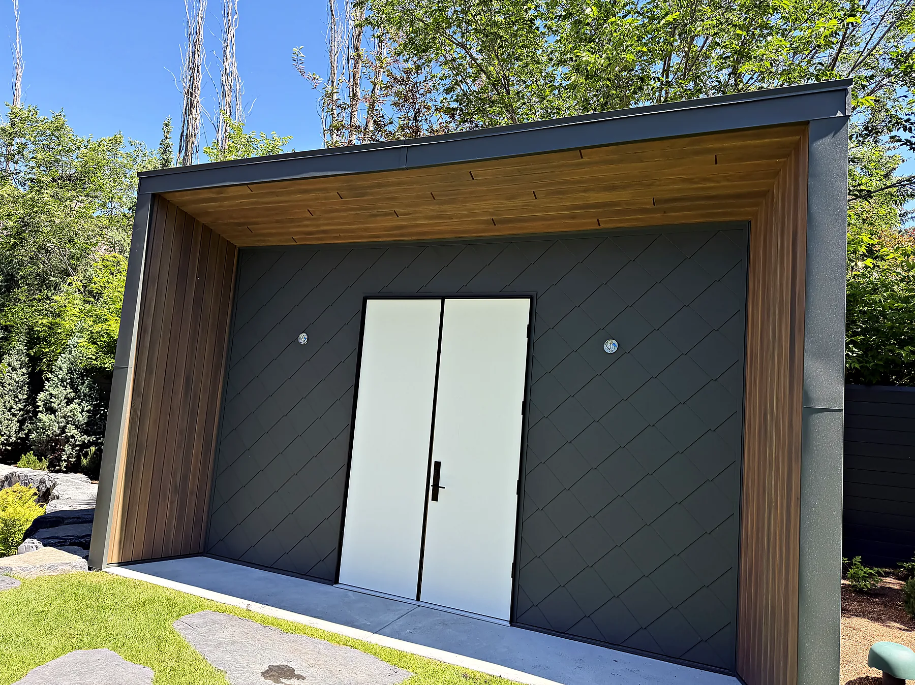 Zinc-clad garden shed with cedar trim